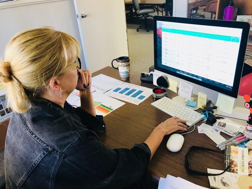 woman in her office using graphs and data to monitor content performance and traffic